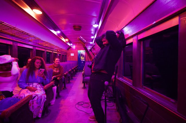 Purple-Lit Vintage Train Car Performance Space