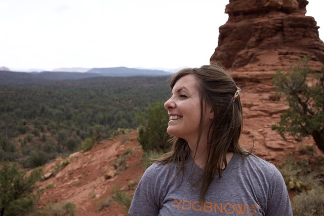 Woman Smiling Atop Red Rock Formation in Sedona