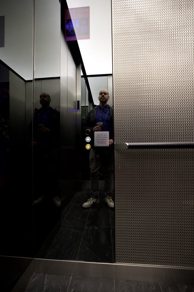 Reflective Self-Portrait in Modern London Elevator