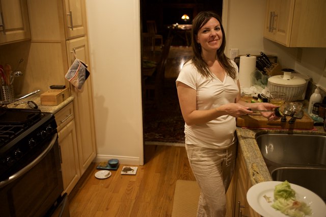 Woman Preparing Food in Warm Kitchen at Night