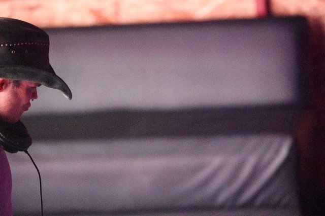 Cowboy Hat DJ in Brooding Stage Shadows