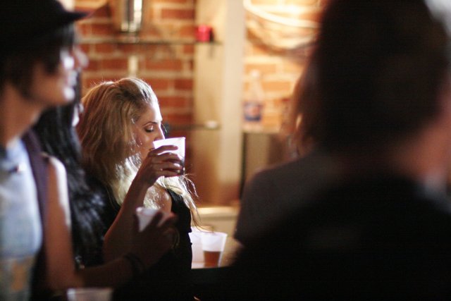 A Woman Enjoying a Beer at a Restaurant