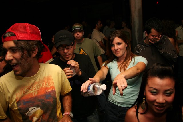 Friends Dancing and Pointing at Night Club Party