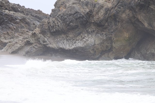 Turbulent Waves Crash Against Rugged Coastal Cliffs