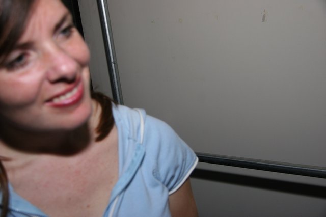 Smiling Woman Peers Around Elevator Door