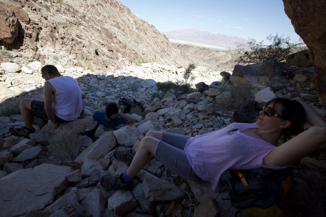 Desert Hikers Resting in Rocky Canyon Shade