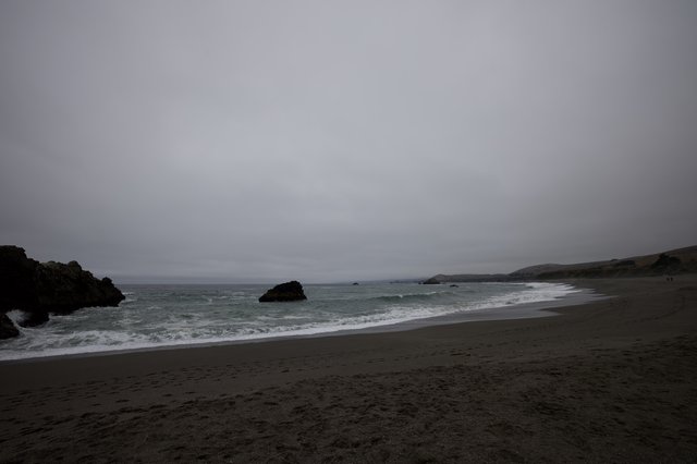 Moody Overcast Beach with Rocky Outcroppings at Dusk