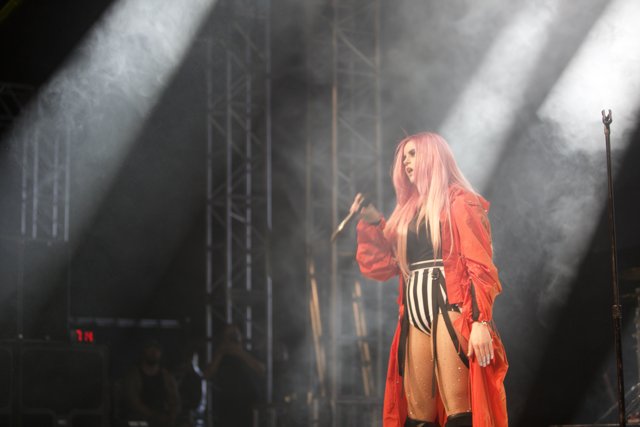 Pink-haired performer rocks the stage in red