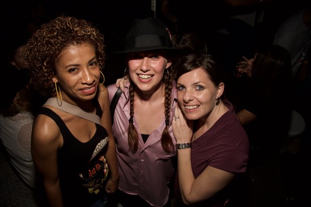Three Friends Smiling at a Nightclub Party