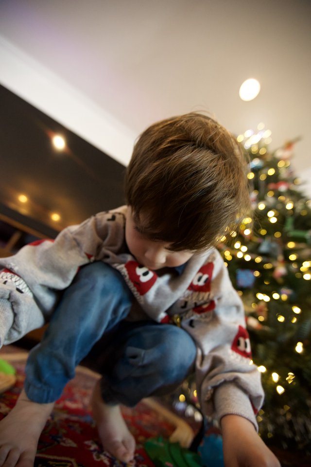 Child Opening Presents on Christmas Morning