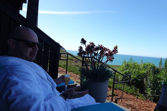 Relaxing oceanside morning in white robe