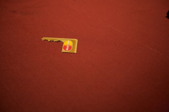 Golden logo pin on red cloth