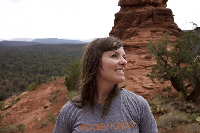 Woman Smiling Atop Sedona Red Rock Formation