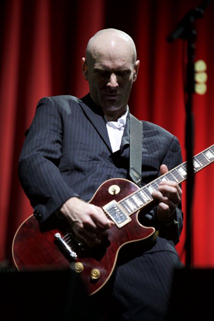 Bald Man in a Suit Shreds Electric Guitar