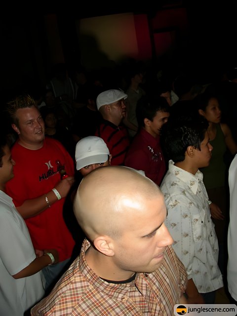 Bald-Headed Man Draws a Crowd at Nightclub