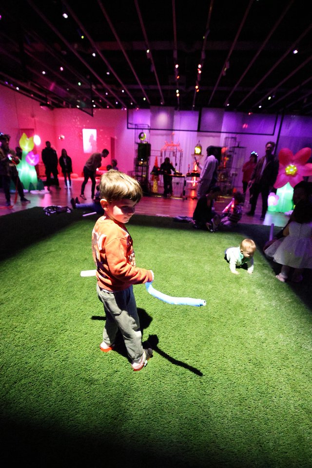 Child Dancing at Colorful Baby Rave Art Installation