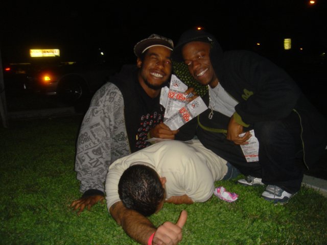 Three Men Enjoying a Night Out on the Grass