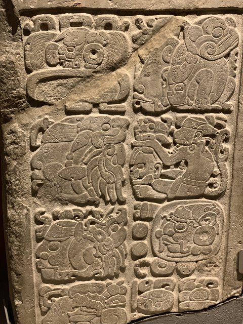 Ancient Stone Carving Depicting Animals and People