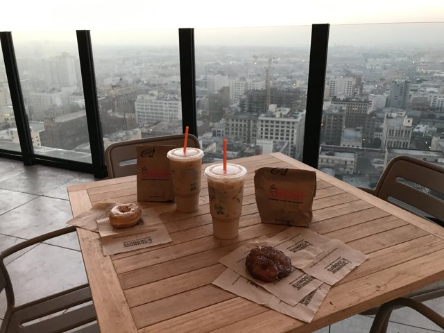 Coffee and Donut on Wooden Table