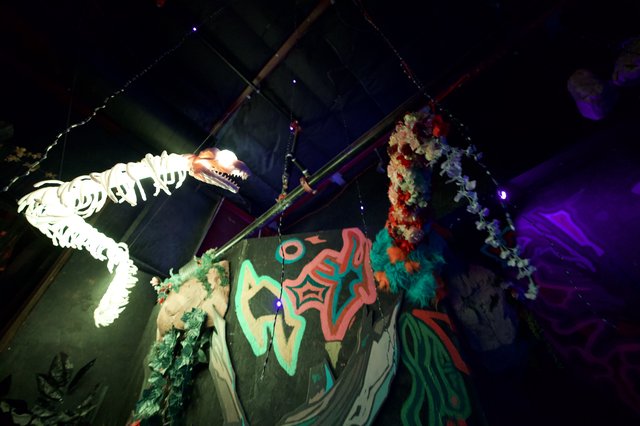 Illuminated Dinosaur Skeleton Display at Night Event