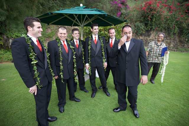 7 Men in Formal Wear Under an Umbrella