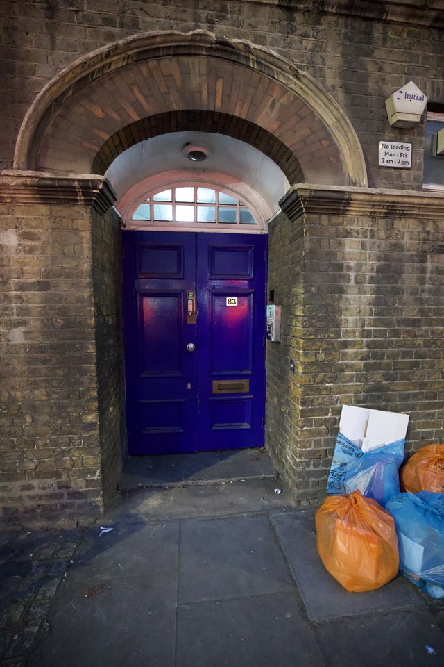 Purple Door Number 83 with Ornate Brick Archway in London
