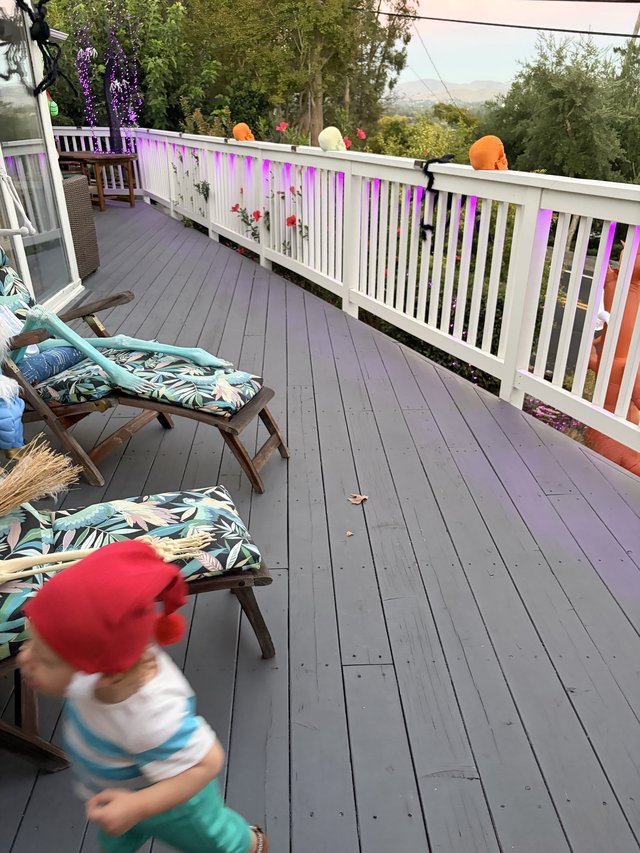 Child in Motion on Decorated Hillside Deck