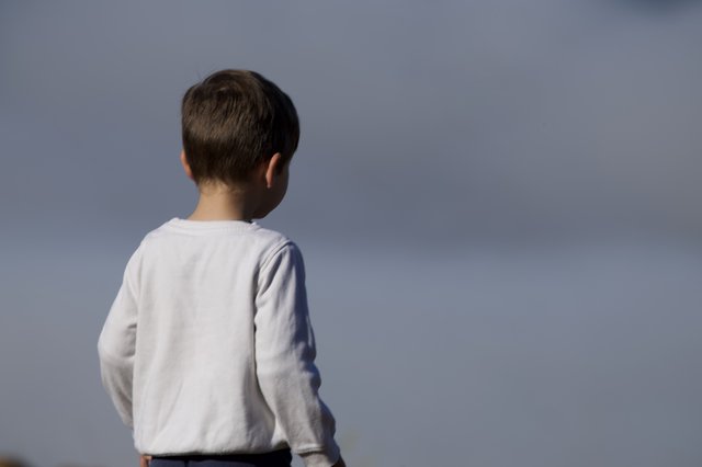 Young Boy Gazes Toward the Horizon in Contemplation