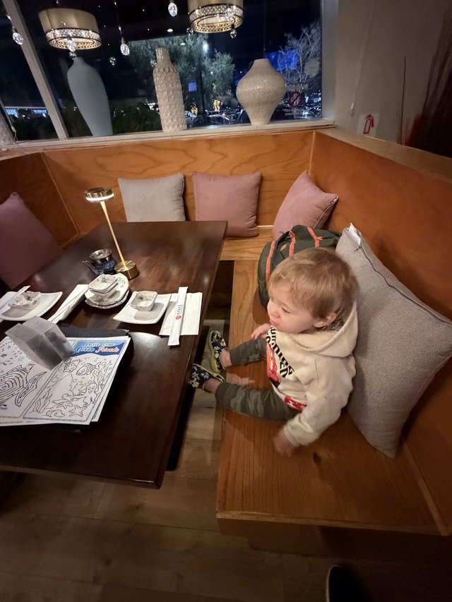 Young Child Dining at Upscale Restaurant Booth