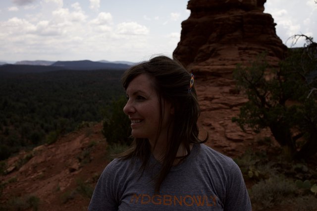 Woman Smiling Atop Red Rock Canyon Vista