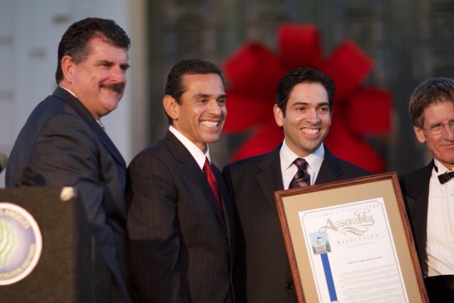 Four Men in Suits Celebrate Award with Antonio Villaraigosa