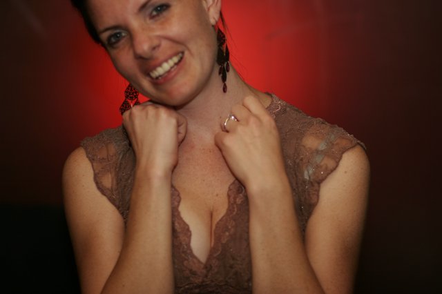 Smiling Woman in Lace Dress at Evening Event