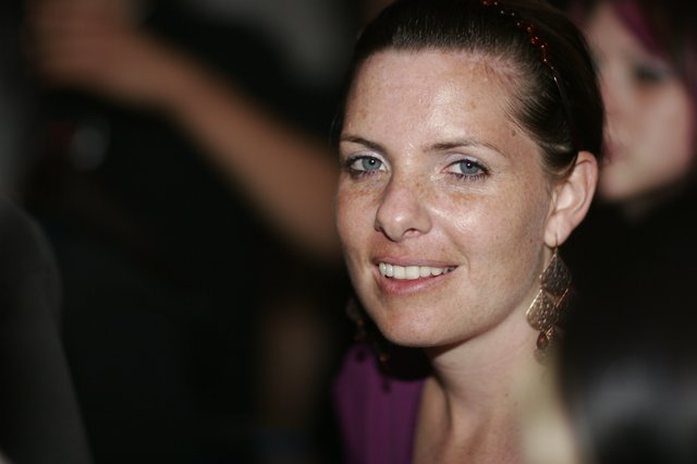 Smiling Woman with Blue Eyes at Evening Event