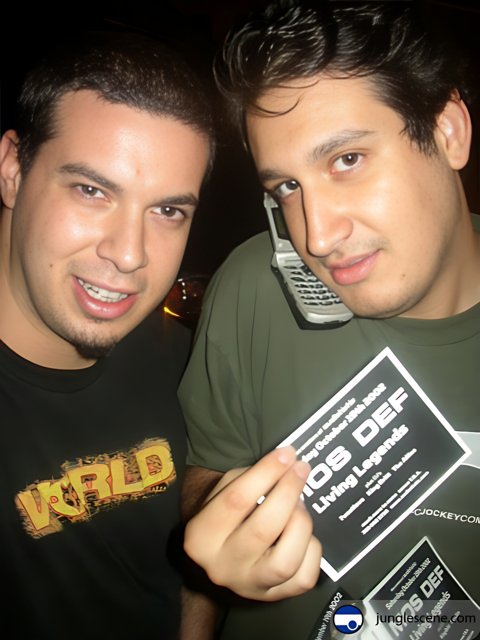 Two men holding up a card with an advertisement
