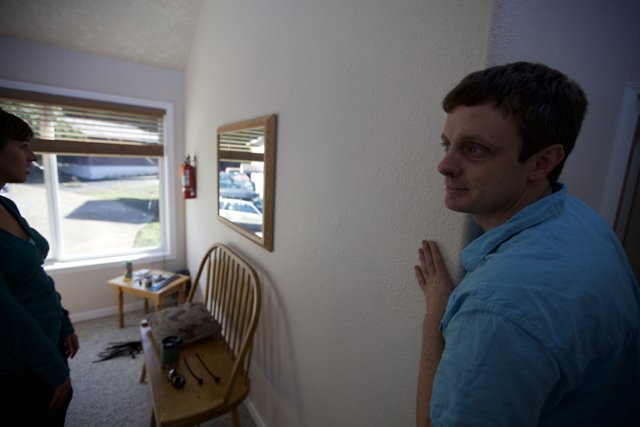 Man Reflects in Living Room Mirror