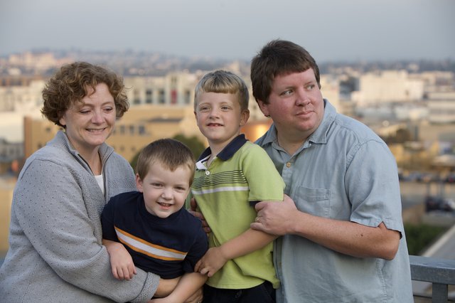 Family Portrait at Dusk with City Skyline