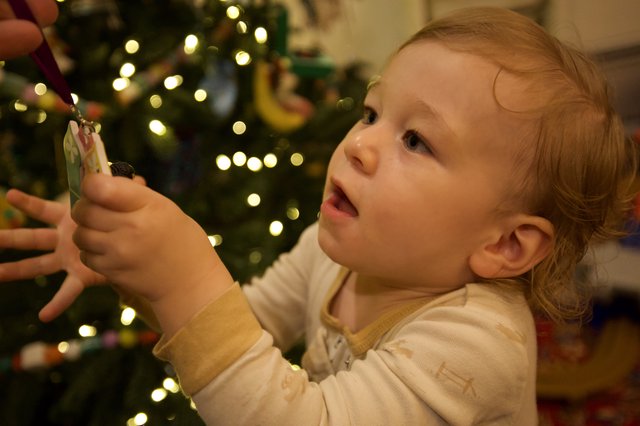 Toddler's Wonder While Decorating the Christmas Tree