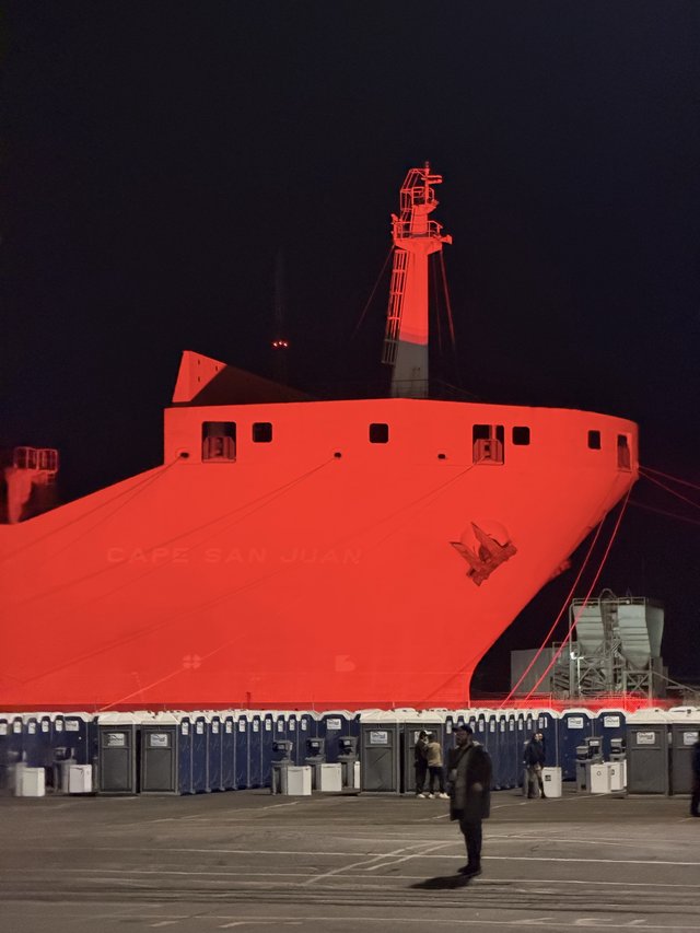Massive Red-Lit Ship Hull at Night Event