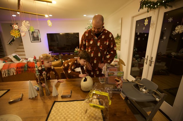 Father and Children Creating Christmas Crafts Together