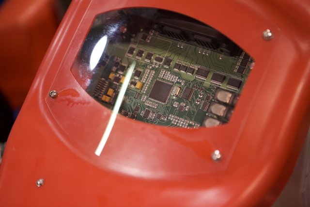 Red Device with Intricate Circuitry