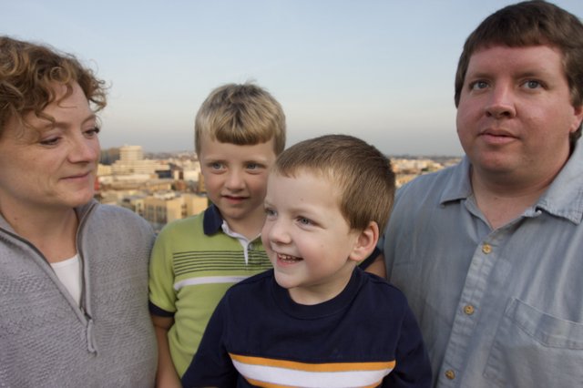 Family Portrait on a City Rooftop at Dusk