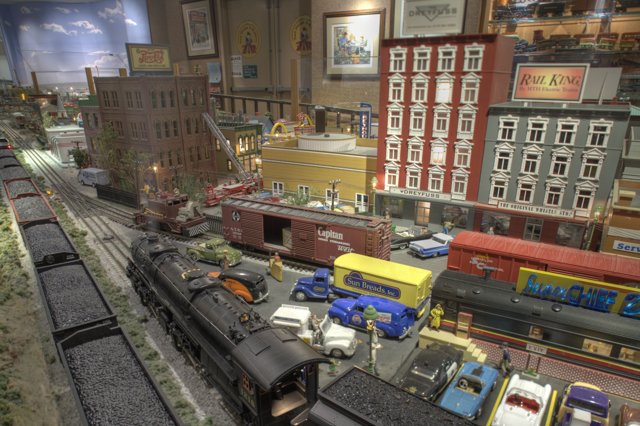 Miniature train and cars in a vibrant diorama