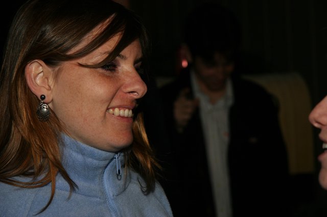 Smiling Woman in Blue Fleece at Evening Event