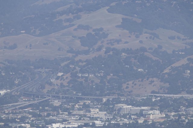 Smoky Haze Over Bay Area Freeway Interchange and Hills