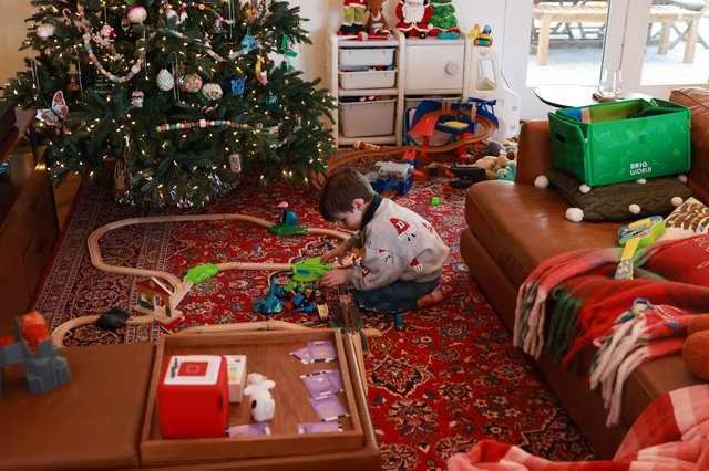 Child Playing with Train Set on Christmas Morning