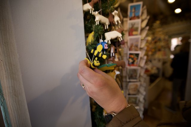 Hand Holding Miniature Bee Figurine in Gift Shop