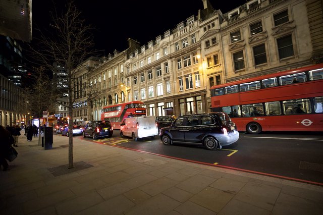Evening Traffic on London Street with Red Double-Decker Buses