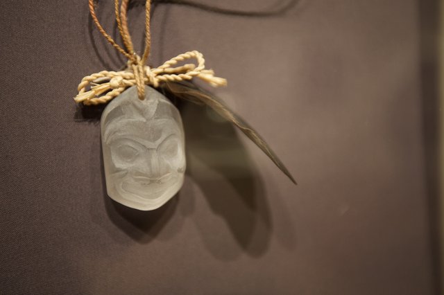 Traditional Carved Pendant with Feather and Rope