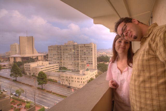 Couple Embracing on Hotel Balcony Over San Francisco