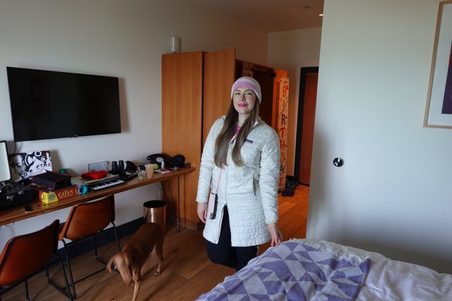 Woman in White Coat Hotel Room Portrait